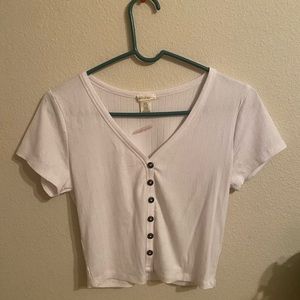 white crop top with button in the front